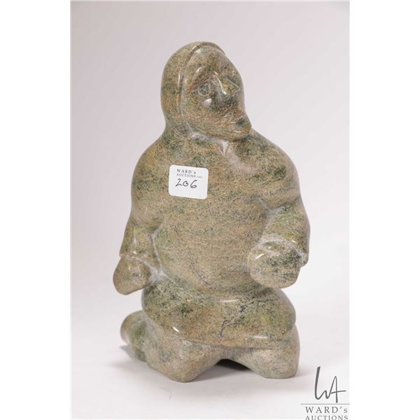 Inuit hand carved green serpentine soapstone kneeling figure, no artist signature seen, 8" in height