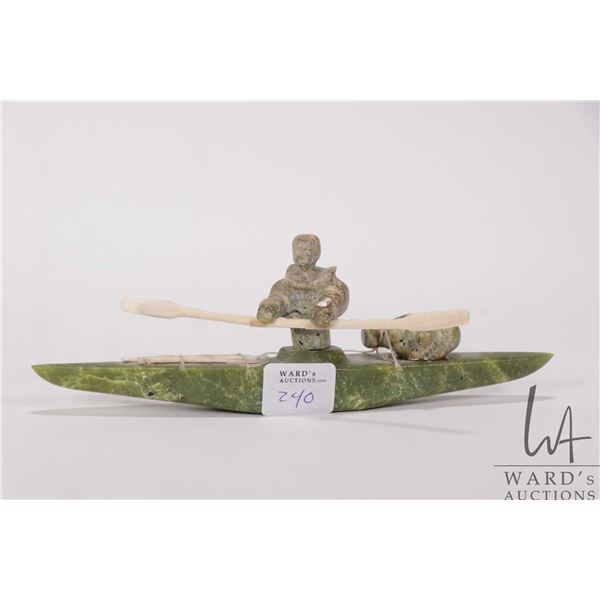Inuit carved green serpentine kayak with rider, paddles and his catch, no artist signature seen, 8" 