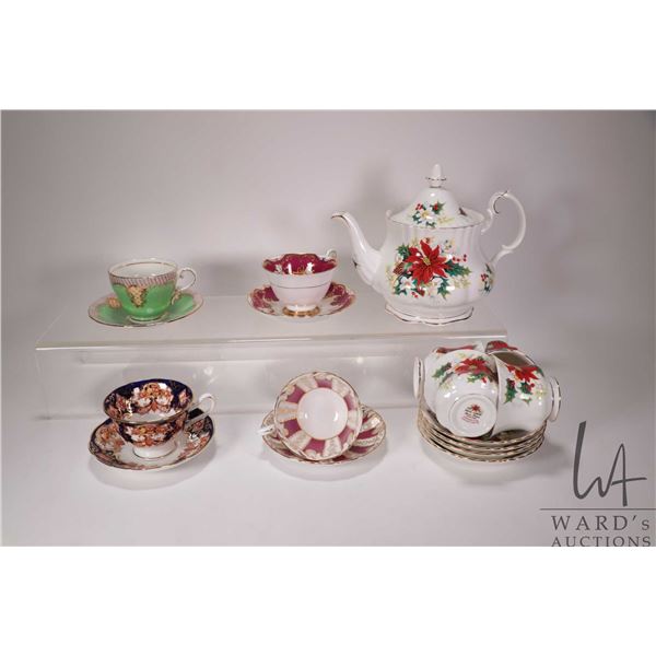 Royal Albert "Poinsettia" teapot and four matching cups and saucers plus four cups and saucers inclu