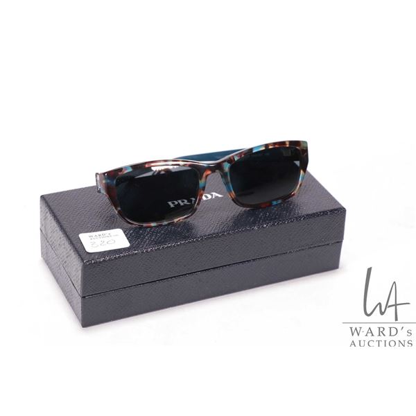 Pair of Prada sunglasses with tortoiseshell like frames, note: currently fitted with prescription le