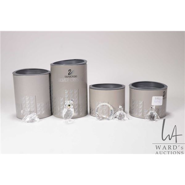 Five Swarovski Crystal figures including Night Owl 206138, Swarovski Swan 7633, Tirol plaque, and tw