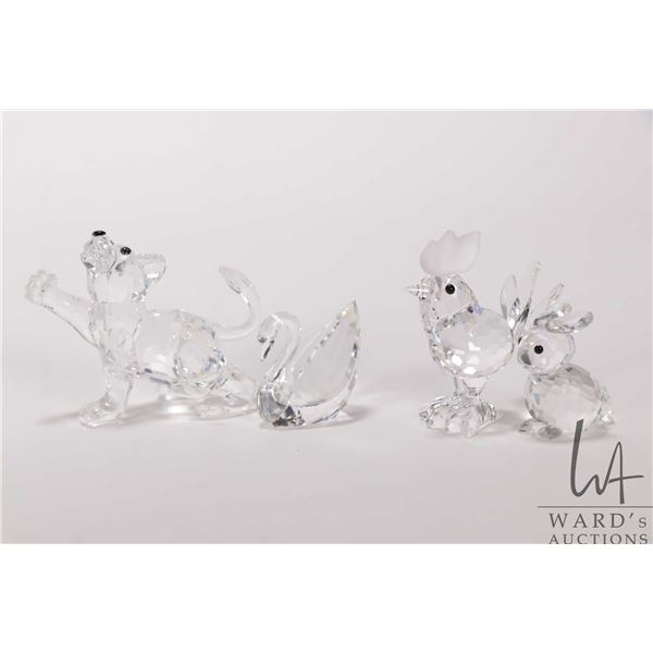 Four Swarovski Crystal figures including Lion Cub 201460, Rabbit 014849, Rooster 014497 and small Sw