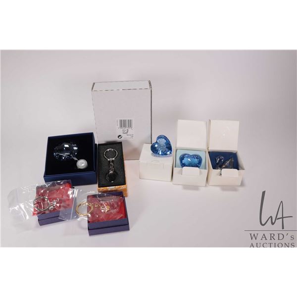 Nine Swarovski collectibles including keychains, two blue hearts, SCS swan and a unopened one year g