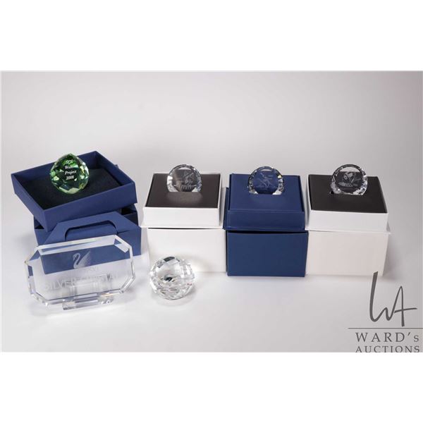 Five Swarovski Crystal collectibles including 2004 event plaque, 1999 event plaque, Silver Crystal d