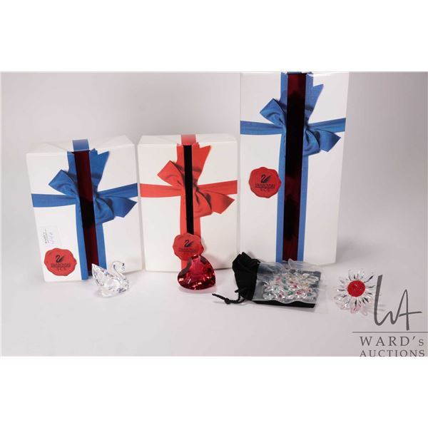 Three Swarovski Crystal SCS gifts including daisy head with bag of small daisies, red heart and swan