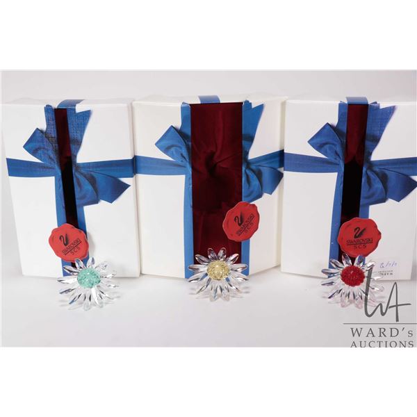 Three Swarovski SCS gifts each containing daisies