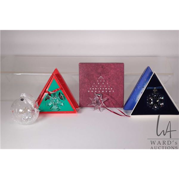 Four Swarovski Crystal ornaments including 1991, 1994 and 1992 snowflakes plus 2015 Christmas ball o