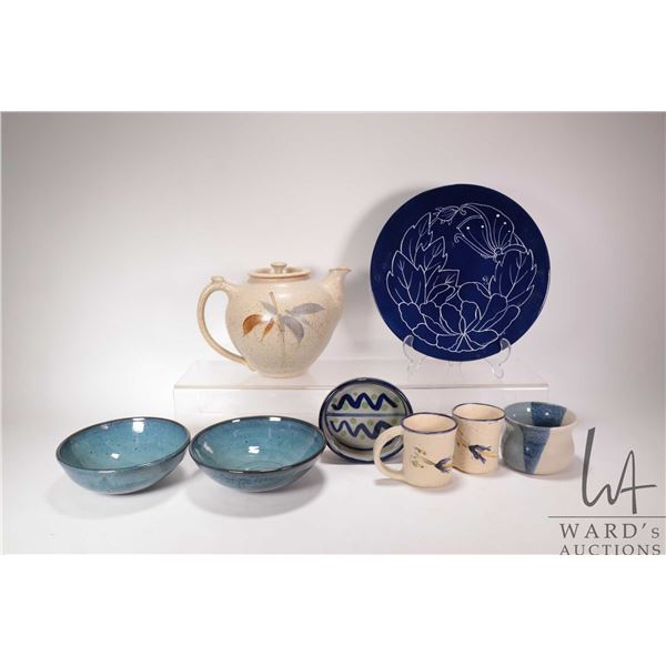 Selection of artisan made pottery including large teapot, two mugs, glazed bowls, plate etc. Some si