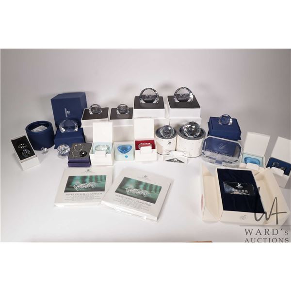 Large selection of Swarovski Crystal paperweights/ and plaques plus SCS gifts and polishing cloths e