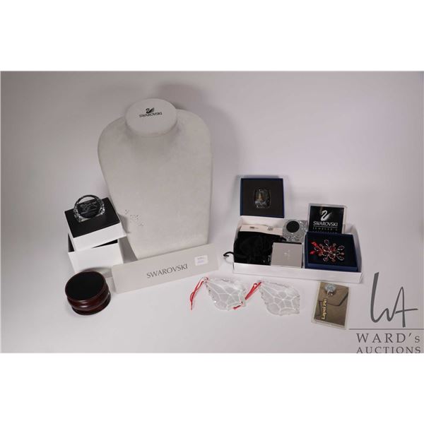 Selection of Swarovski crystal branded items including necklace stand, pins, plaques, paperweights e