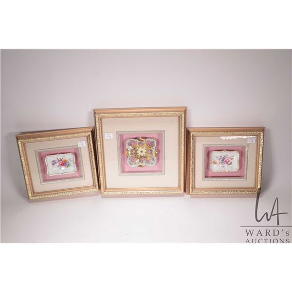 Three small decorative handpainted dish in gilt framed shadowboxes including two 9" X10" and one 12"