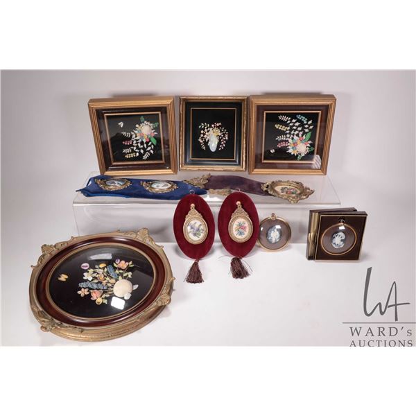 Selection of shadow box framed shell art, decorative needlework wall hangings, small framed cameos e