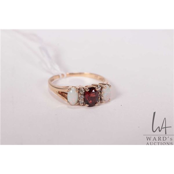 10kt yellow gold ring set with two opal, oval cut garnet and six diamond accent gemstones, size 6.5