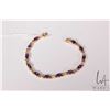 Image 1 : 14kt yellow gold X link bracelet set with twelve oval cut amethyst gemstones, 7.5" in length
