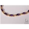 Image 2 : 14kt yellow gold X link bracelet set with twelve oval cut amethyst gemstones, 7.5" in length