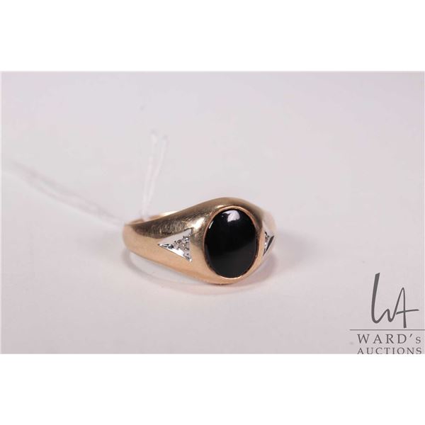 Gent's 10kt yellow gold and oval cabochon onyx ring set with two small single cut accent diamonds. R