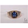 Image 2 : Gent's 10kt yellow gold ring set with synthetic blue star sapphire and .005cts of round single cut d