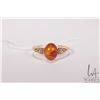 Image 2 : Tested 10kt gold ring set with cabochon amber stone, size 8