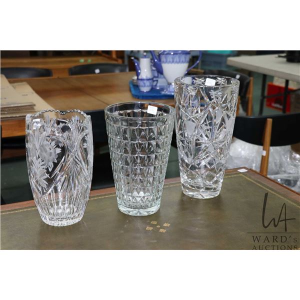 Three glass vases including etched crystal with roses 10" in height plus a 12" crystal vase and a E.
