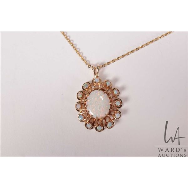 Tested 14kt yellow gold and opal pendant on 17" gold toned neck chain