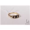 Image 1 : Vintage 18kt yellow gold ring set with three dark blue sapphire gemstones and four accent diamonds. 