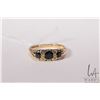 Image 2 : Vintage 18kt yellow gold ring set with three dark blue sapphire gemstones and four accent diamonds. 