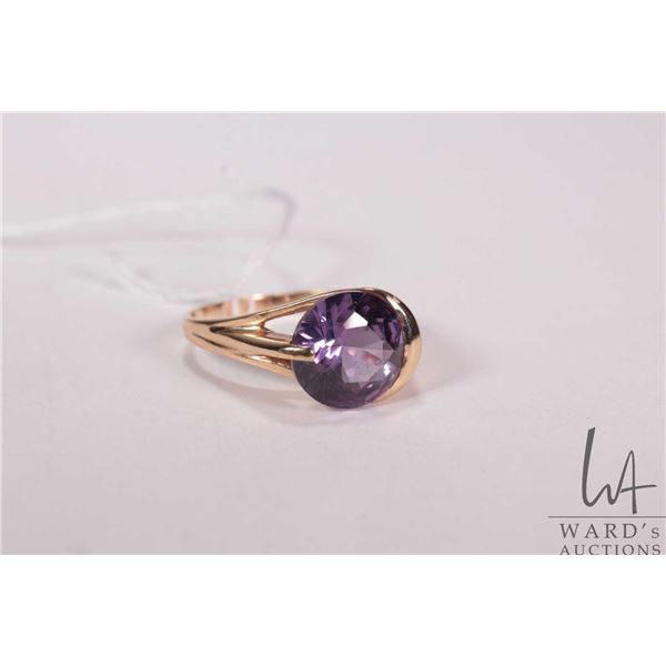 10kt yellow gold ring set with purple gemstone that tests at sapphire, size 7.5