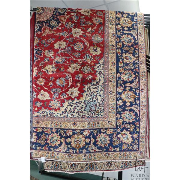 Iranian wool carpet "Esafahan" with center medallion, red background and highlights of blues, creams