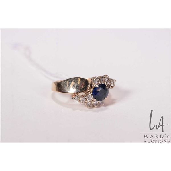 14kt white gold, oval cut sapphire and round brilliant cut diamond cluster ring, size 8