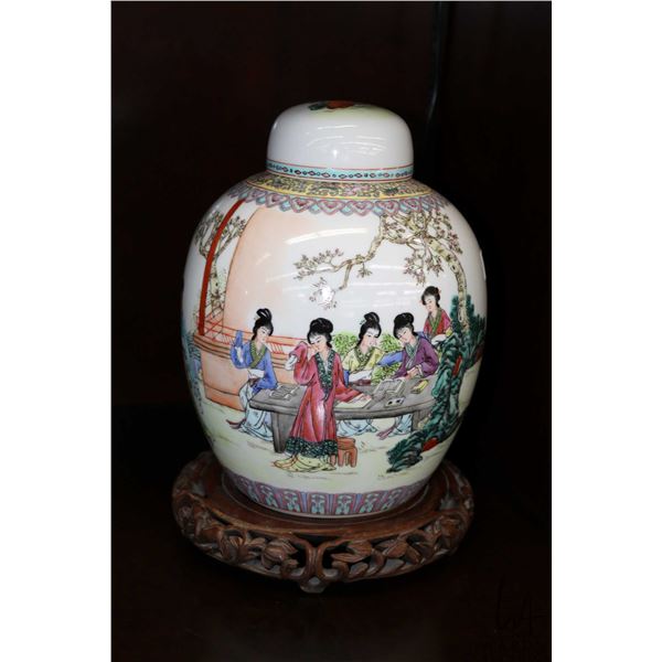 Chinese porcelain ginger jar with figures studying in a court yard. Includes carved wooden plinth