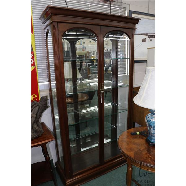 Semi contemporary two door, illuminated curio/ display cabinet with four adjustable glass shelves, m