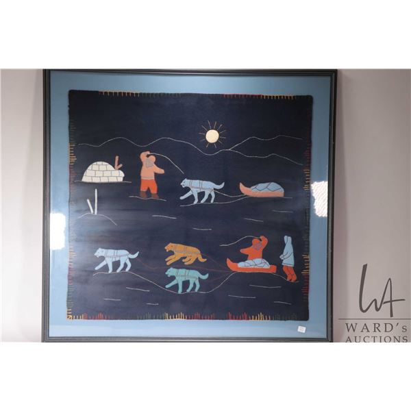 Inuit art hand made wool applique Kiluk featuring a Inuit hunter with dog sled, overall dimensions i
