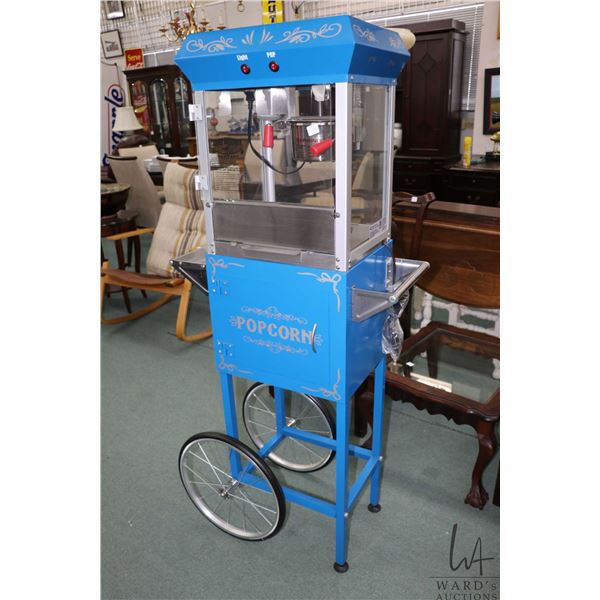 Fountain style popcorn maker machine, appears new with warming light, accessories and machine cart o