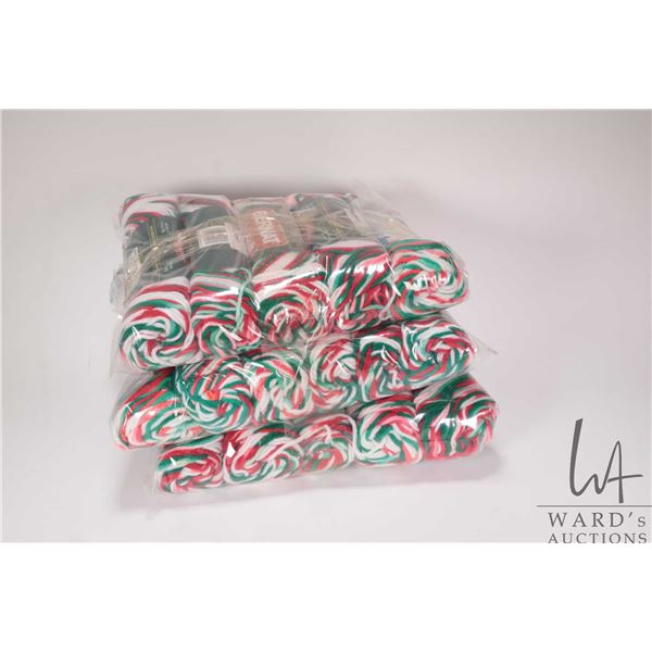 Sixteen 50 gram balls of Bernat So-Soft red, white and green knitting yarn