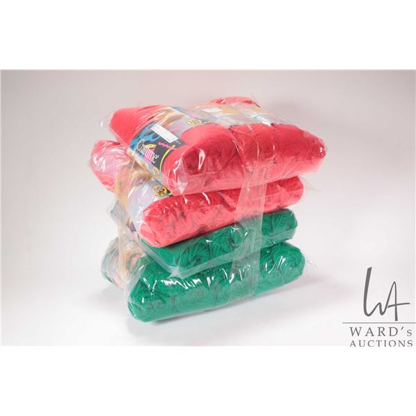 Approximately twenty five balls of Zellers Craftime 50 gram yarn in green and red