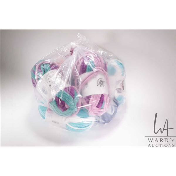 Nine full and one open balls of Sweet Snuggle Stripes knitting yarn