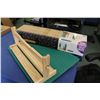 Image 1 : Pine table top paper roll dispenser, a box Sauder wooden quilt rack, a Sew Steady portable table by 