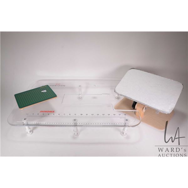 Janome acrylic free arm extender plus a turn table cutting mat and a table top embroidery table
