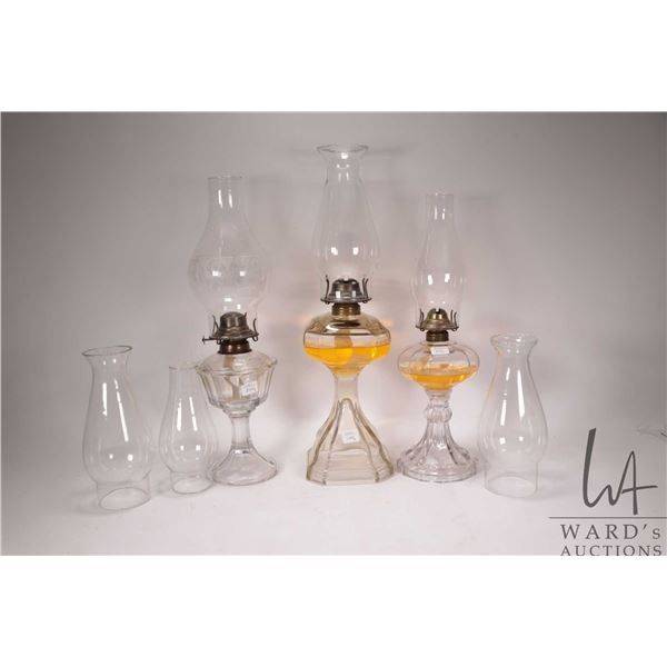 3 vintage clear glass oil lanters with chimneys plus 3 spare chimneys