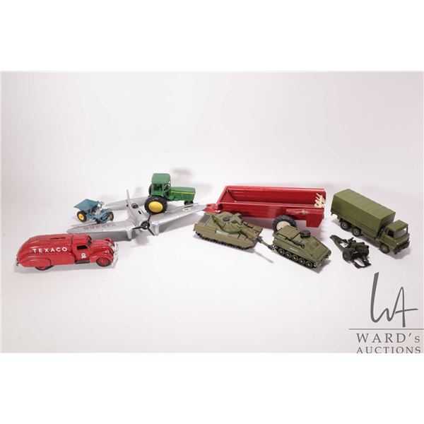 Selection of vintage toys including Dinky military vehicles, Ertl piggy bank fire truck, piggy bank 