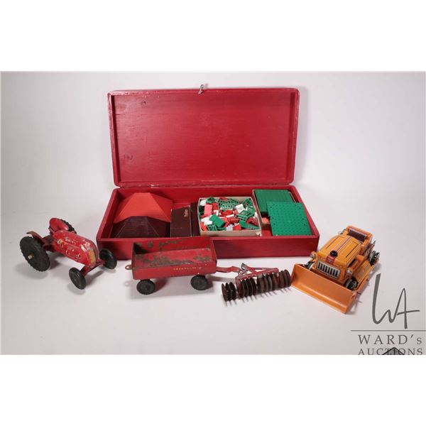 Selection of vintage toys including a die cast Cockshutt Model 30 Row Crop tractor with disc and tra