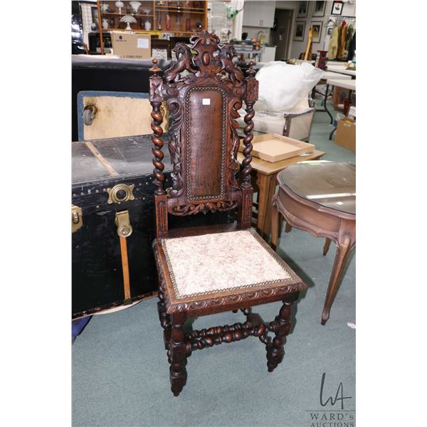 Antique Renaissance Revival oak chair with prominent barley twist support and ornate carved lion mot