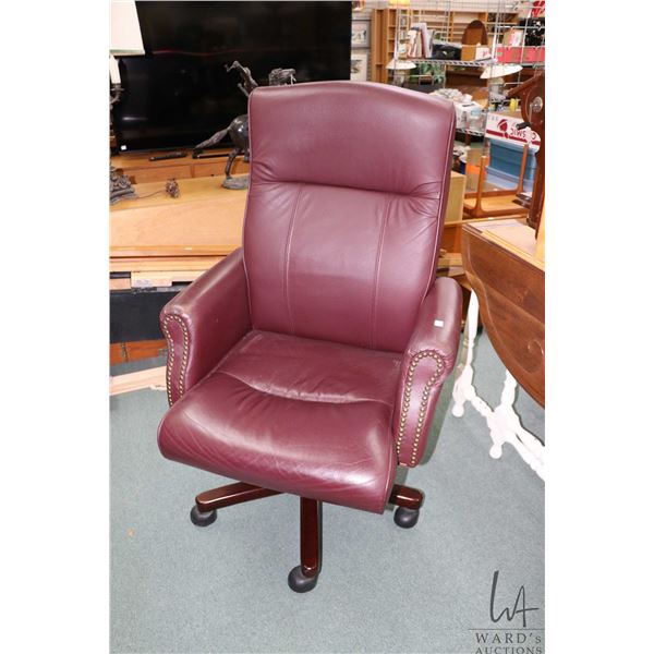 Modern swivel office with burgundy upholstery and nailhead decoration