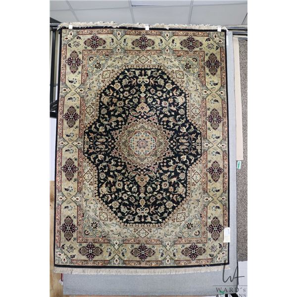 Hand woven wool and silk Kashmir area carpet with center medallion, floral design and highlights of 