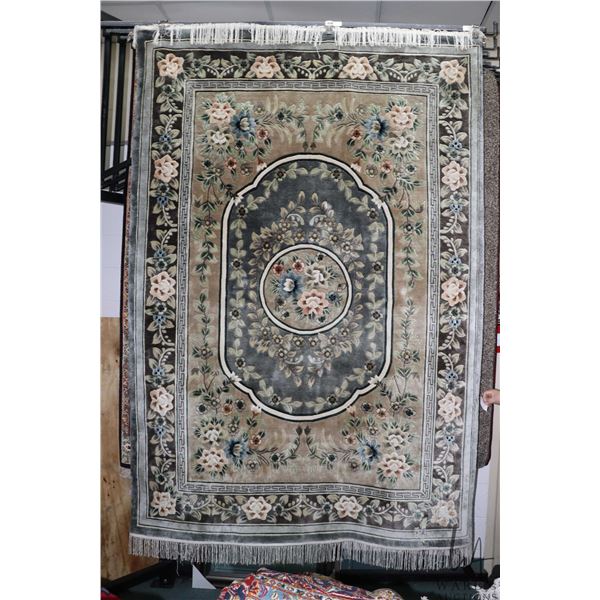 Soft sculpted wool carpet with overall grey hues, center medallion, floral design and highlights of 