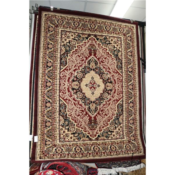 Modern polyester area carpet with center medallion, burgundy background and highlights of black, cre