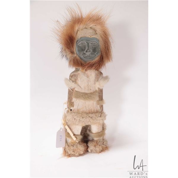 Inuit soapstone figure with whale bone body and seal skin clothing, 13" in height