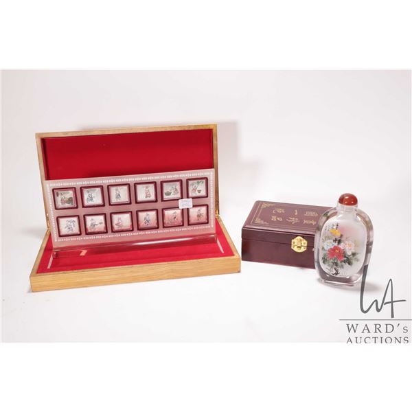 Asian silver over copper twelve piece set "Year of the Rabbit" with acrylic display stand and a 6" h