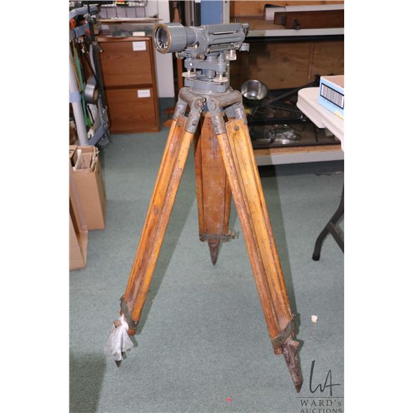 Vintage surveyors transit made by Cooke, Troughton & Simms Ltd. England, on wooden tri-pod base