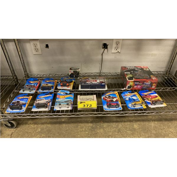 SHELF OF ASSORTED DIECAST VEHICLES (HOTWHEELS, LEXMARK & MORE) & A TRANSFORMERS POSTER PUZZLE
